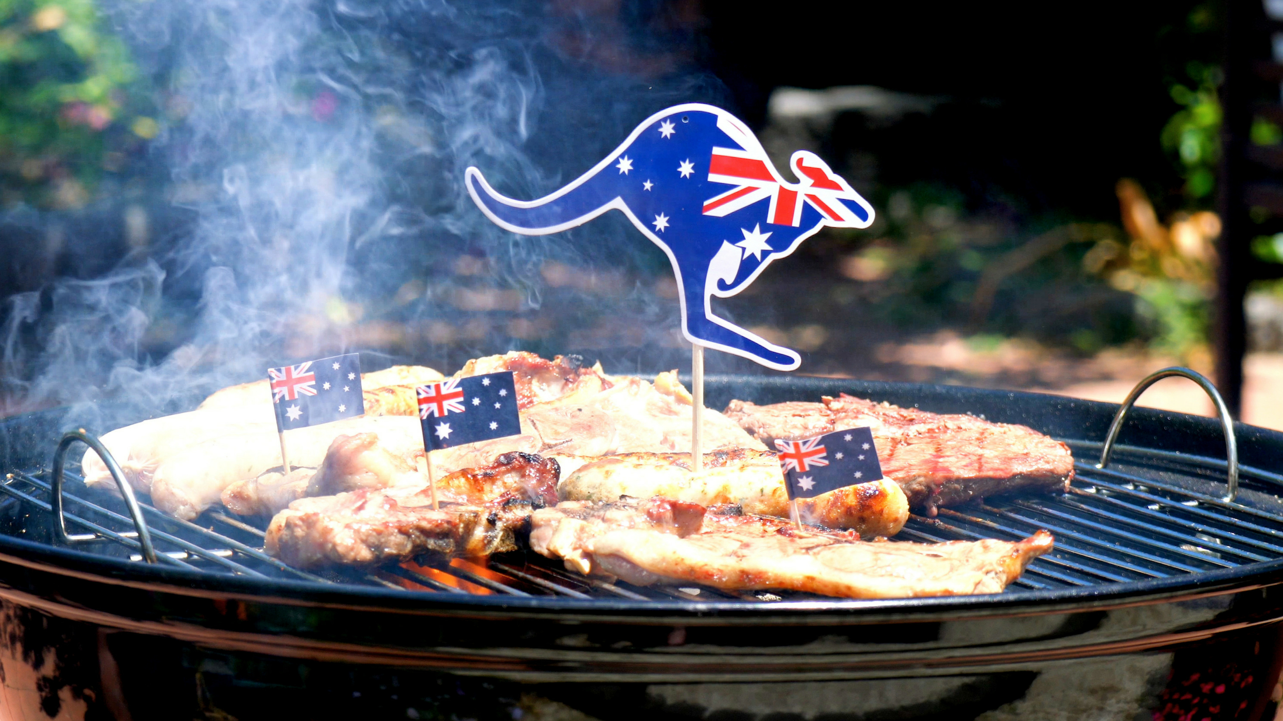 Meat-cooking-on-a-BBQ-with-a-kangaroo-shaped-Australian-Flag-toothpick