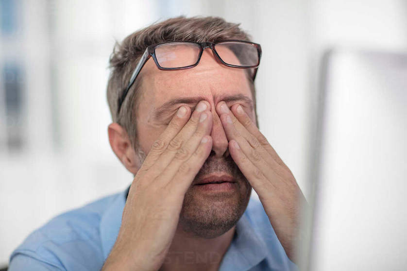 stressed-man-rubbing-eyes-image