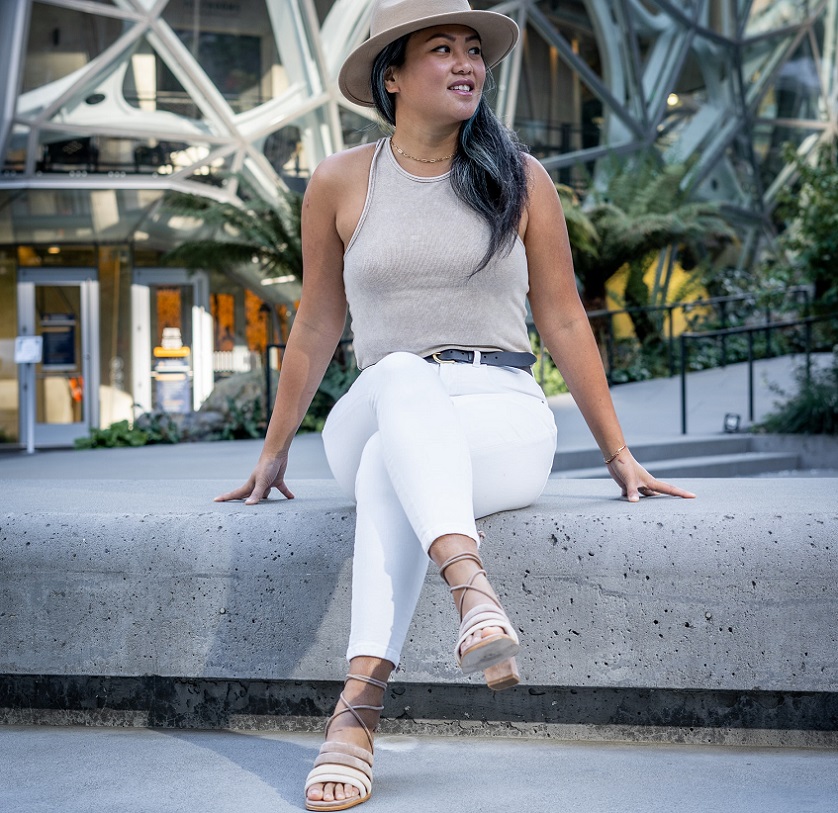 picture of a woman sitting on a concrete wearing stylish clothes and heel sandals 