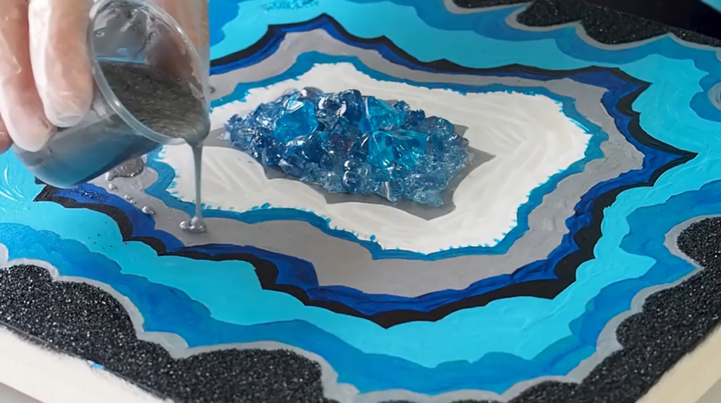 Surface resin differs from deep pour resin in several ways, but one of the most noticeable is that top-pour resin is substantially thicker than deep pour resin. So keep in mind that making art with resin does not have to be a complicated deep pour attempt; it may serve as a long-lasting good-looking covering for several surfaces that is adaptable, simple to apply, easily available, and very resistant to a variety of external influences.
But why is it thicker? Because deep pour resin is meant to be dispensed in huge volumes in a single space, it must be thinner to limit the density of the resin in a specific space (it also makes it easier to pour but that might just be a lucky by-product). Top-pour resins are thicker since only a finite amount is needed and spread over the surface of a certain 