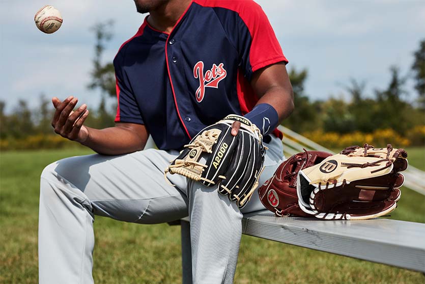 Man playing with a ball for baseball and wearing a baseball glove