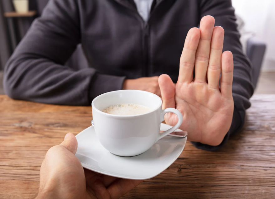 Man refusing to take a cup of coffee