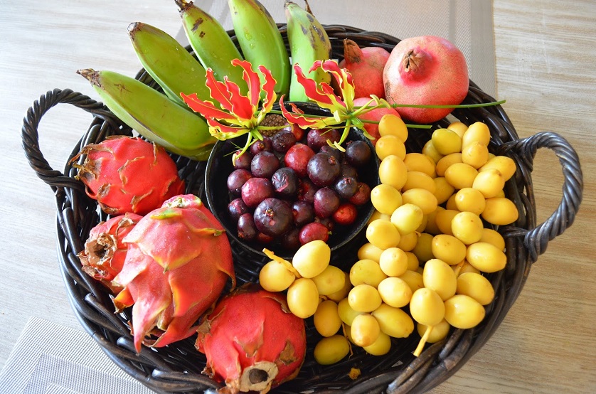 tropical fruits in a bowl on table 