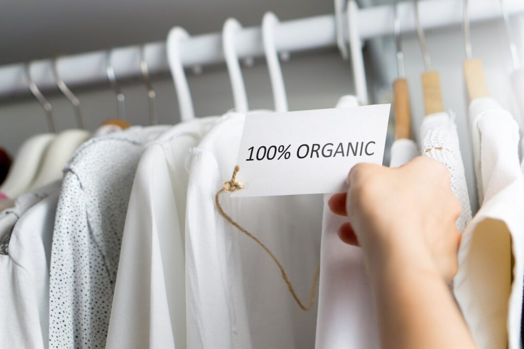 bunch of white clothing and sign with 100% organic