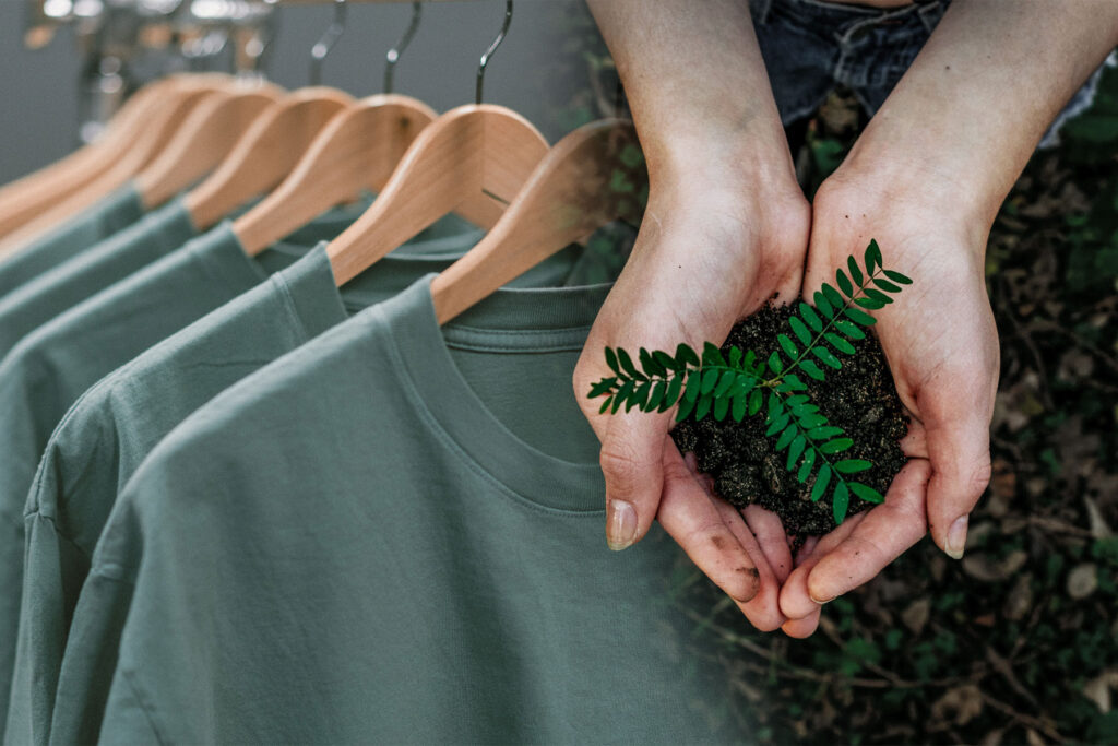 Woman is holding plant and behind her hands are bunch of t-shirts