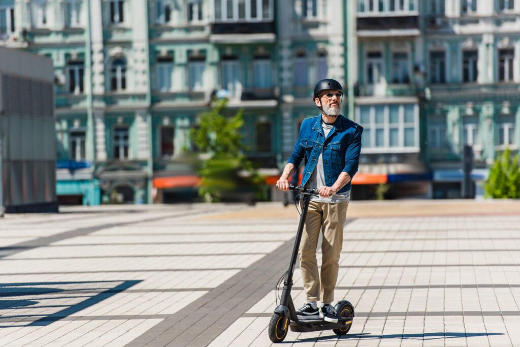 a man wearing a helmet and riding a scooter
