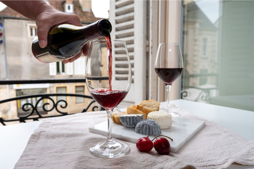 glasses full of pinot noir and served cheese